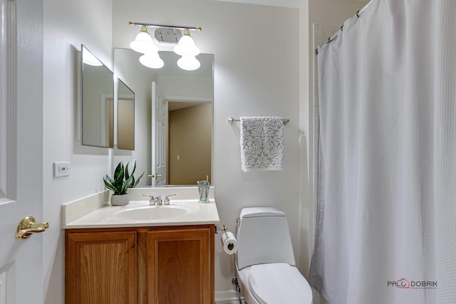 bathroom with vanity, a shower with shower curtain, and toilet