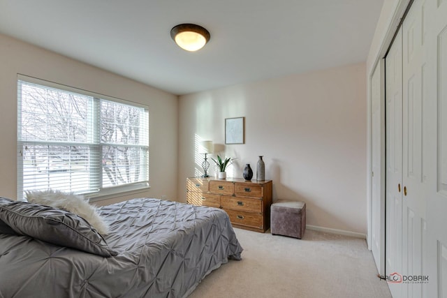 bedroom featuring light carpet and a closet