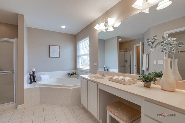 bathroom featuring tile patterned flooring, vanity, and shower with separate bathtub