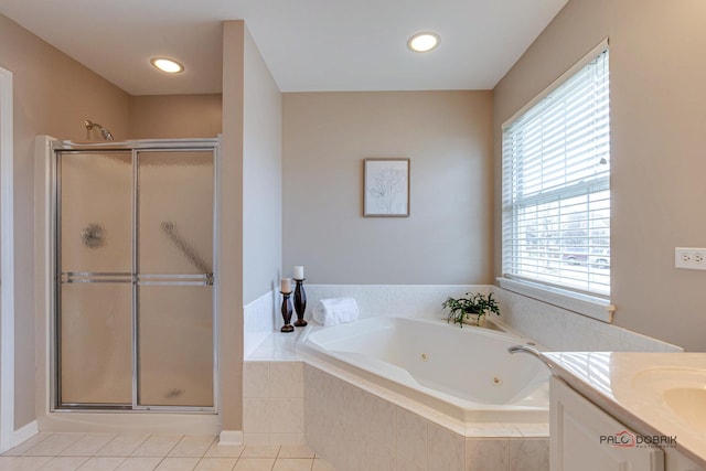 bathroom with tile patterned flooring, plenty of natural light, separate shower and tub, and vanity