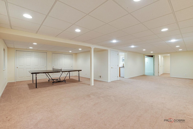 recreation room featuring light carpet