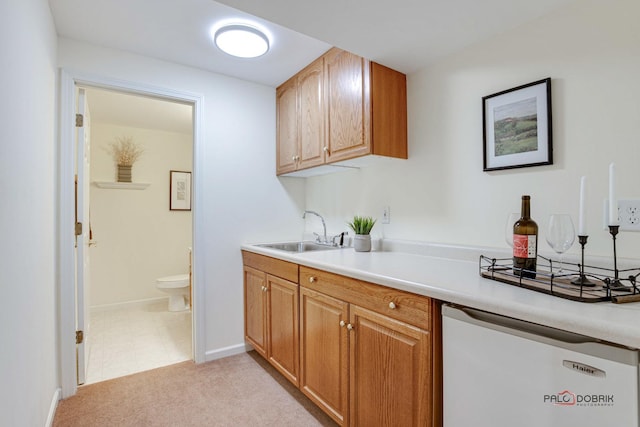 kitchen featuring light carpet, white dishwasher, and sink