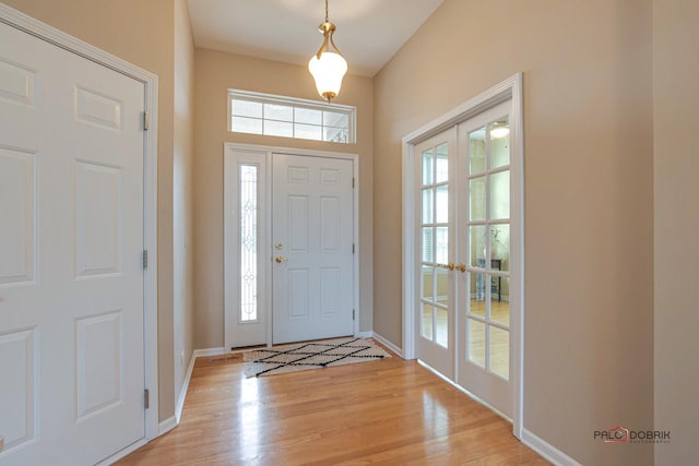 entryway featuring french doors, light hardwood / wood-style floors, and a wealth of natural light