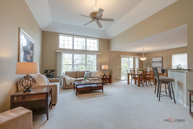 living room with light carpet, high vaulted ceiling, and ceiling fan