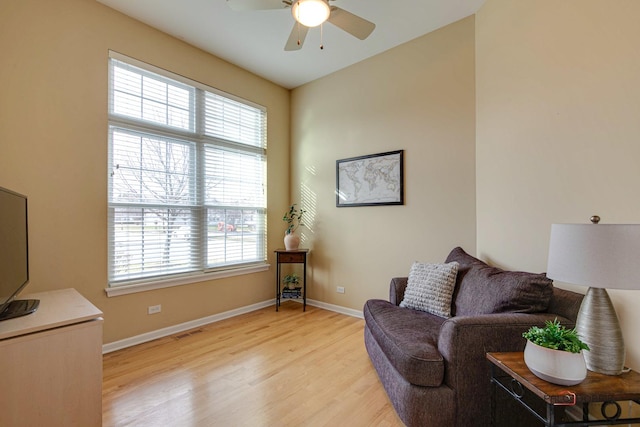 living area featuring ceiling fan and light hardwood / wood-style floors