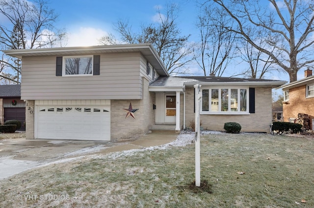 tri-level home with a garage and a front yard