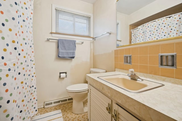 bathroom with curtained shower, toilet, vanity, and a baseboard heating unit