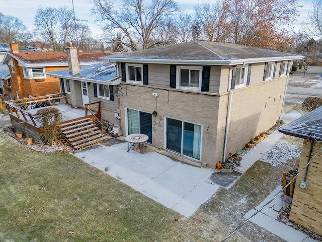 back of house with a lawn, a wall unit AC, a patio, and a deck