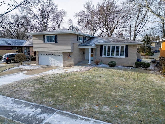 tri-level home featuring a garage and a front lawn