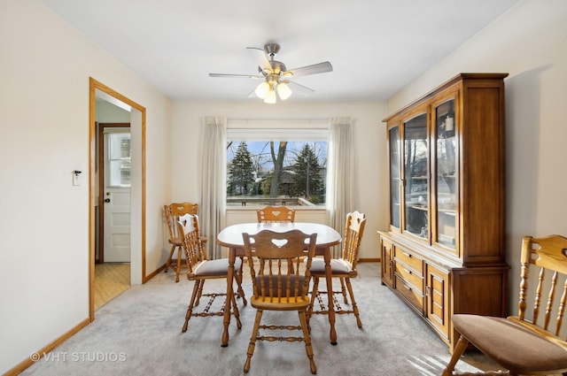 carpeted dining space featuring ceiling fan