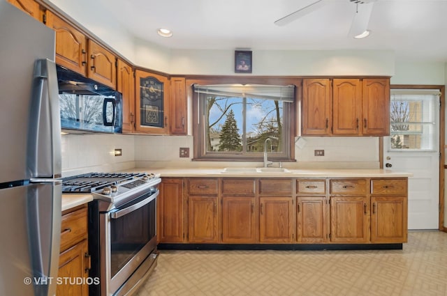 kitchen with appliances with stainless steel finishes, ceiling fan, plenty of natural light, and sink