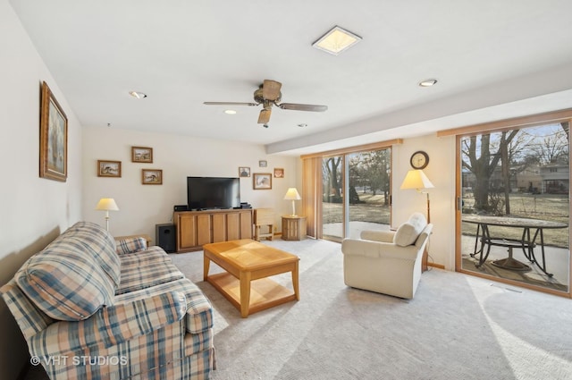 carpeted living room featuring ceiling fan