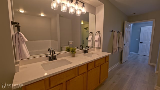 full bathroom with independent shower and bath, vanity, wood-type flooring, and toilet