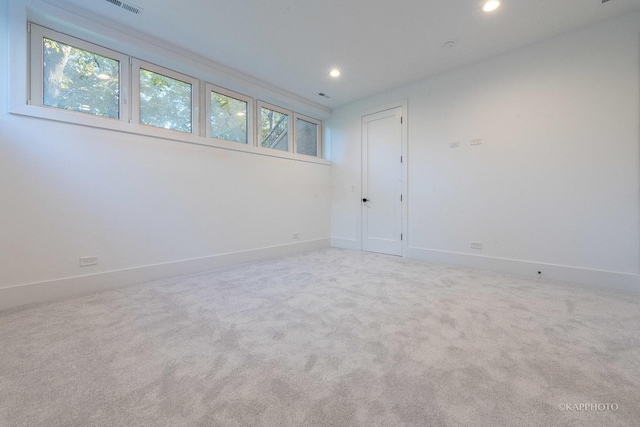 carpeted spare room featuring plenty of natural light