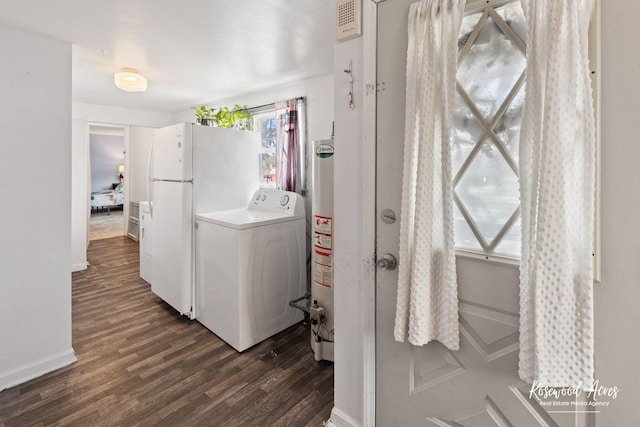 clothes washing area with water heater, plenty of natural light, dark hardwood / wood-style floors, and washer / dryer