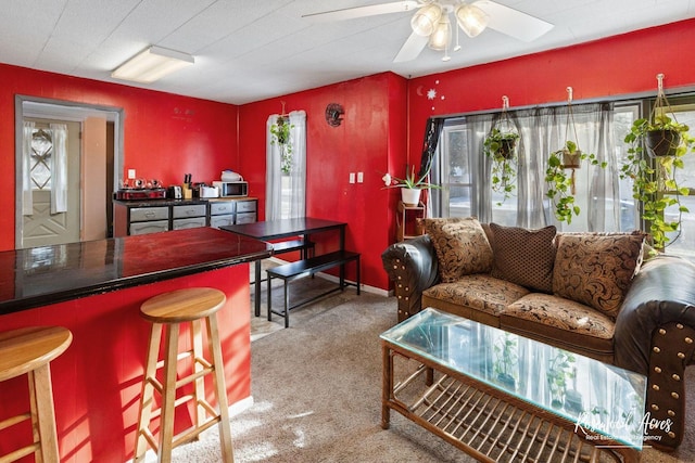 living room with ceiling fan and carpet floors