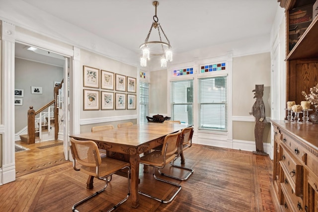 dining space featuring a chandelier and parquet floors