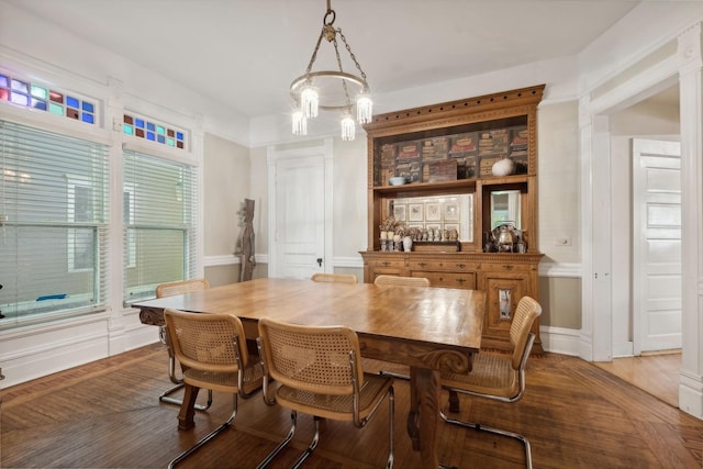 dining space featuring hardwood / wood-style floors and a chandelier