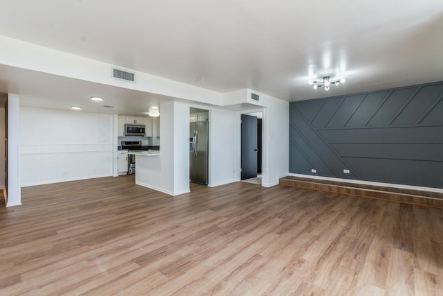 unfurnished living room with light hardwood / wood-style flooring