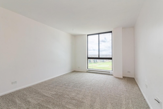 carpeted empty room with a baseboard radiator and a wall of windows