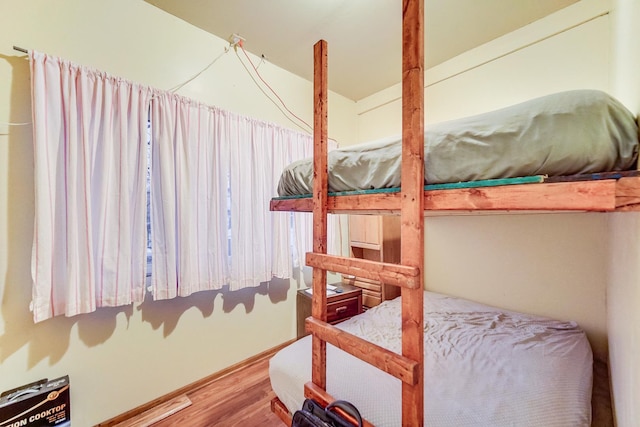 bedroom with hardwood / wood-style floors