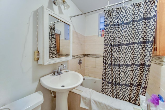 bathroom with shower / bath combo and toilet