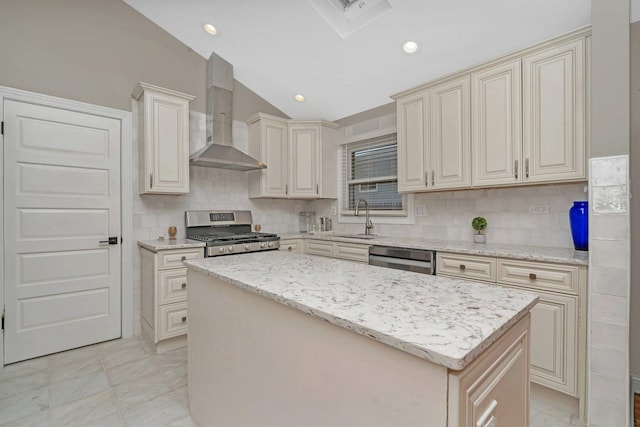 kitchen with dishwashing machine, a center island, light stone counters, stainless steel range oven, and wall chimney exhaust hood