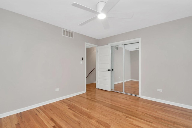 unfurnished bedroom with ceiling fan, hardwood / wood-style floors, and a closet