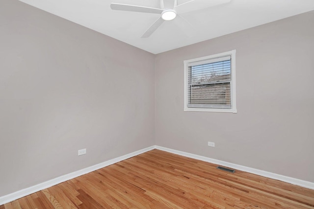 spare room with hardwood / wood-style flooring and ceiling fan