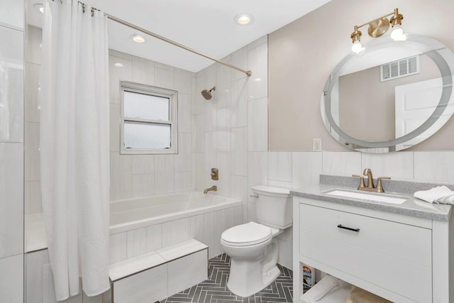 full bathroom with vanity, tile walls, shower / bathtub combination with curtain, and toilet