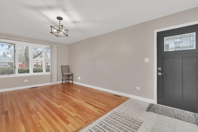 entrance foyer featuring a notable chandelier and hardwood / wood-style flooring