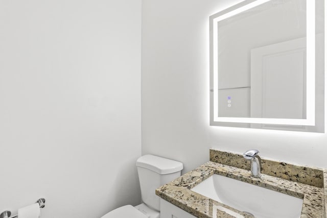 bathroom with toilet and vanity