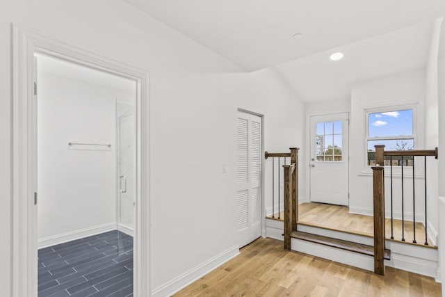 interior space with wood-type flooring and vaulted ceiling