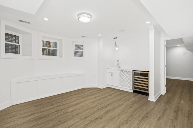 bar featuring pendant lighting, dark hardwood / wood-style flooring, and wine cooler