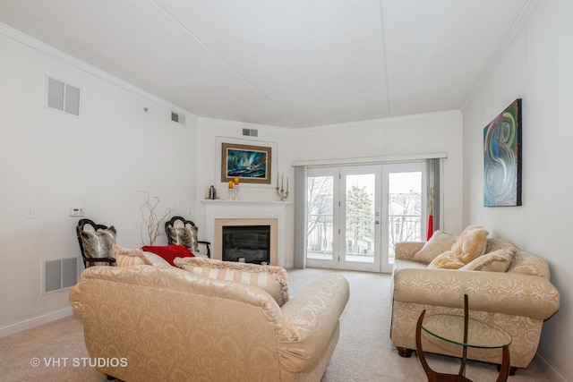 carpeted living room with french doors and crown molding