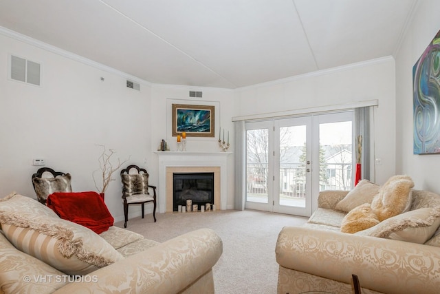 carpeted living room with french doors and ornamental molding