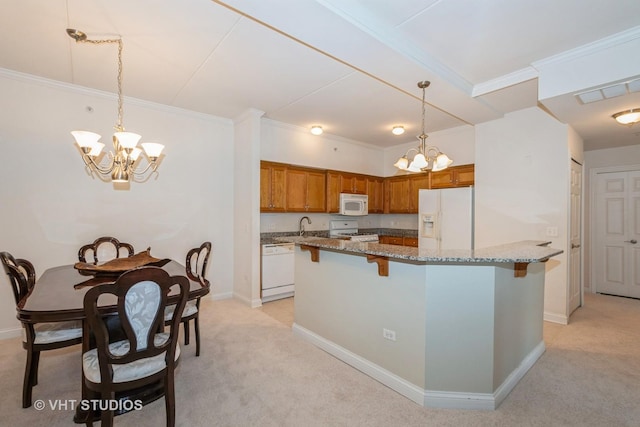 kitchen with pendant lighting, light colored carpet, white appliances, light stone countertops, and an inviting chandelier