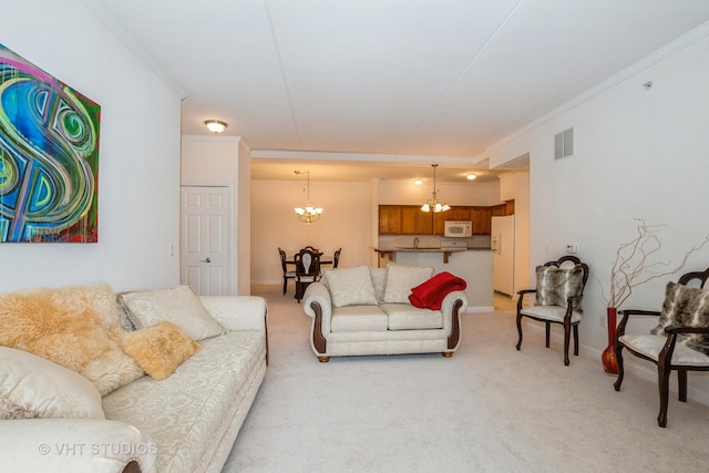 carpeted living room with ornamental molding and a chandelier