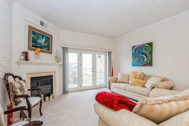 living room with light carpet, crown molding, a high end fireplace, and french doors