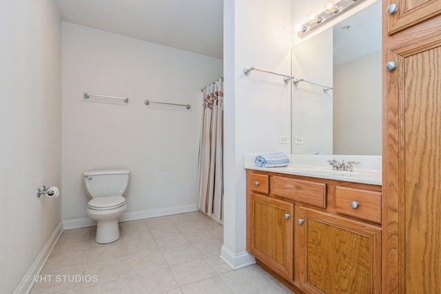 bathroom with vanity, toilet, and tile patterned flooring