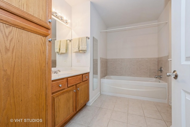 bathroom featuring vanity, tile patterned flooring, and a washtub