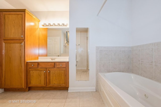 bathroom featuring tile patterned flooring, a bath, and vanity