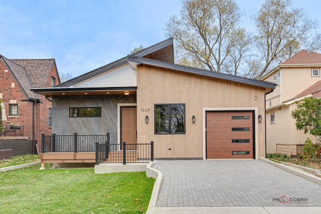 view of front of house with a garage and a front lawn