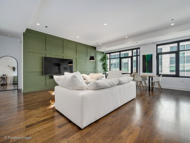 living room featuring dark hardwood / wood-style flooring and plenty of natural light