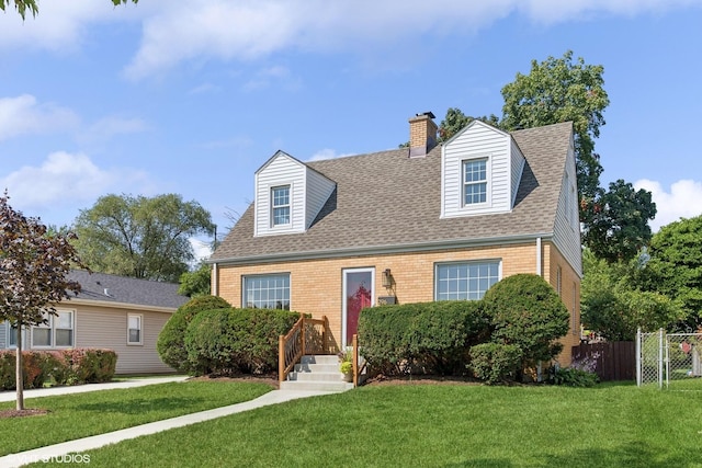 cape cod-style house featuring a front lawn