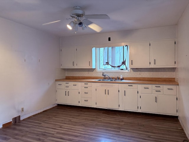 kitchen with ceiling fan, sink, dark wood-type flooring, tasteful backsplash, and white cabinets