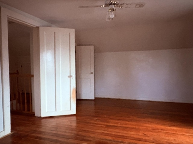 additional living space featuring dark hardwood / wood-style flooring and ceiling fan