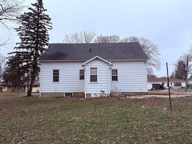 rear view of property with a lawn