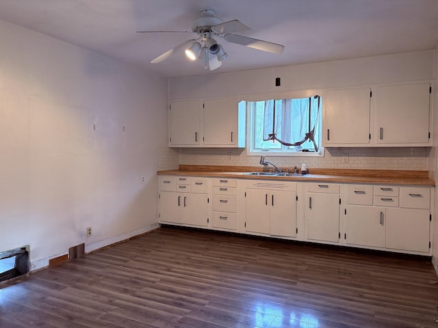 kitchen featuring white cabinetry, ceiling fan, dark wood-type flooring, and sink