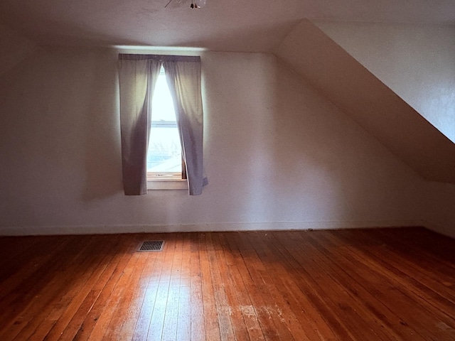 bonus room featuring hardwood / wood-style flooring and lofted ceiling